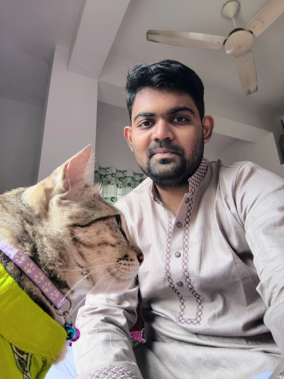 Mahir Faisal with his cat in a full-frame portrait